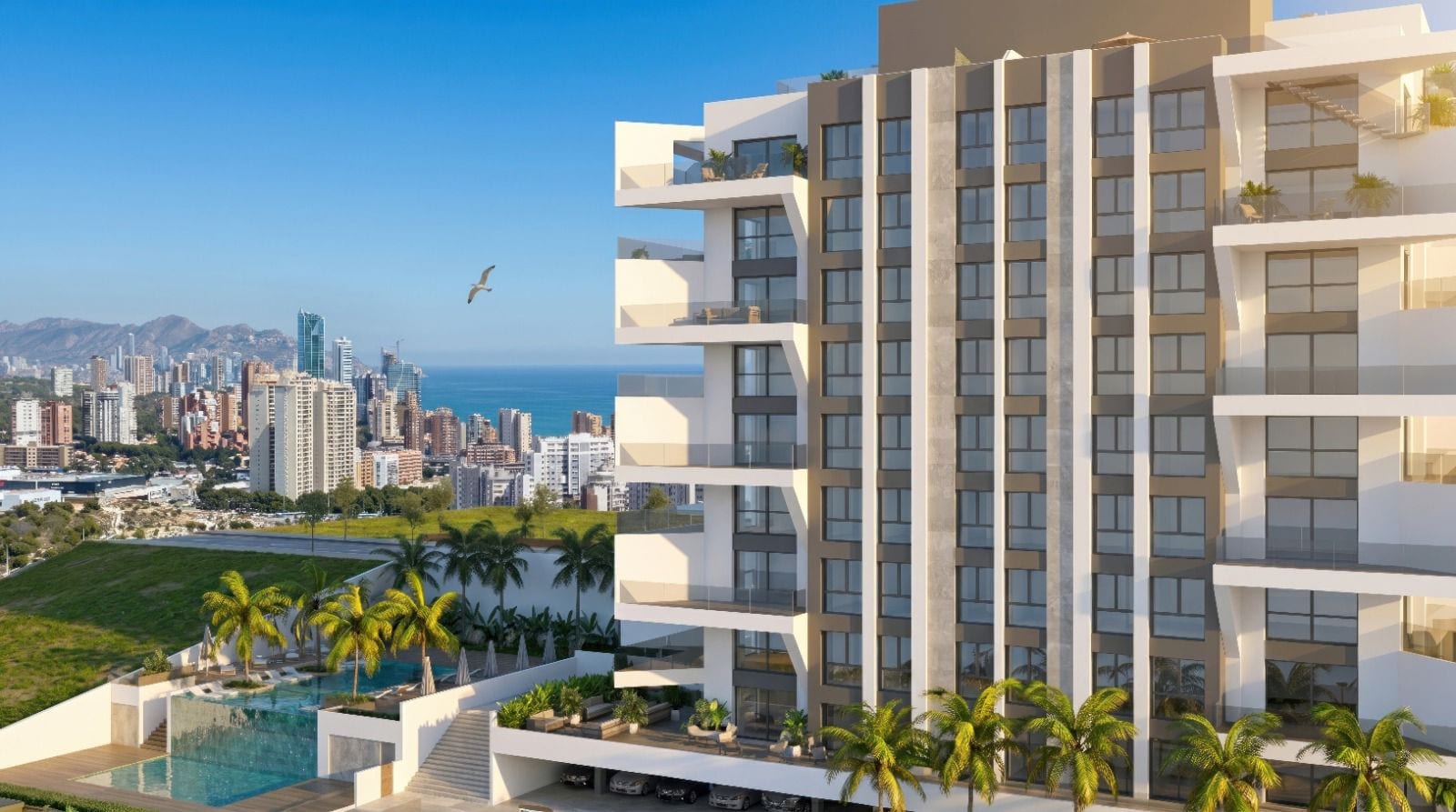 Infografía 3D del edificio proyectado por SAVO en Villajoyosa, con la bahía y el perfil de rascacielos de Benidorm al fondo